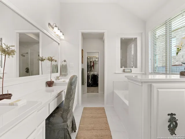 a en suite bathroom with a double vanity sink a mirror and a shower