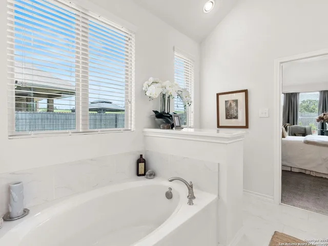 a bathroom with a bathtub and a sink