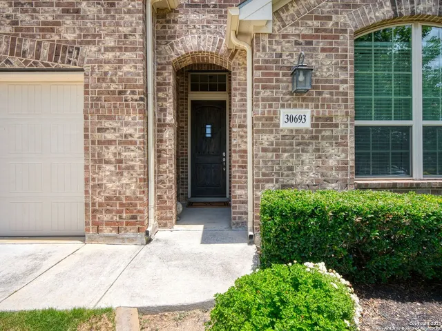 a front view of a house with potted plants