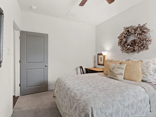 a bedroom with a bed and a painting on the wall