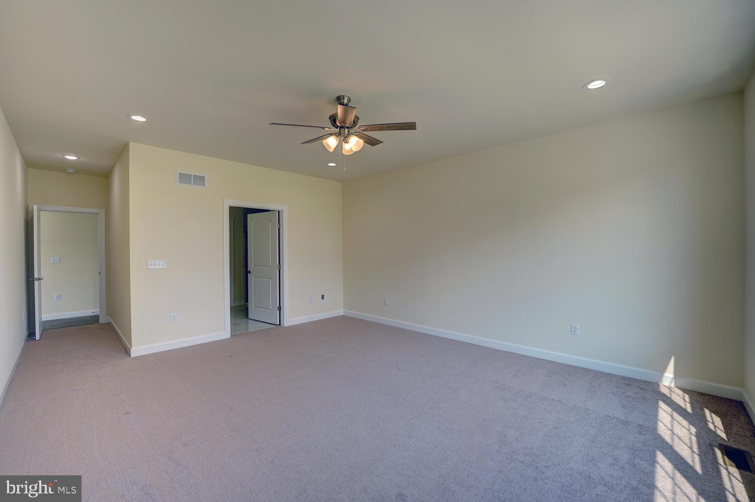 29 Mapledale Road Dover, DE 19904 - Photo 31 of 65 an empty room with a ceiling fan and a window
