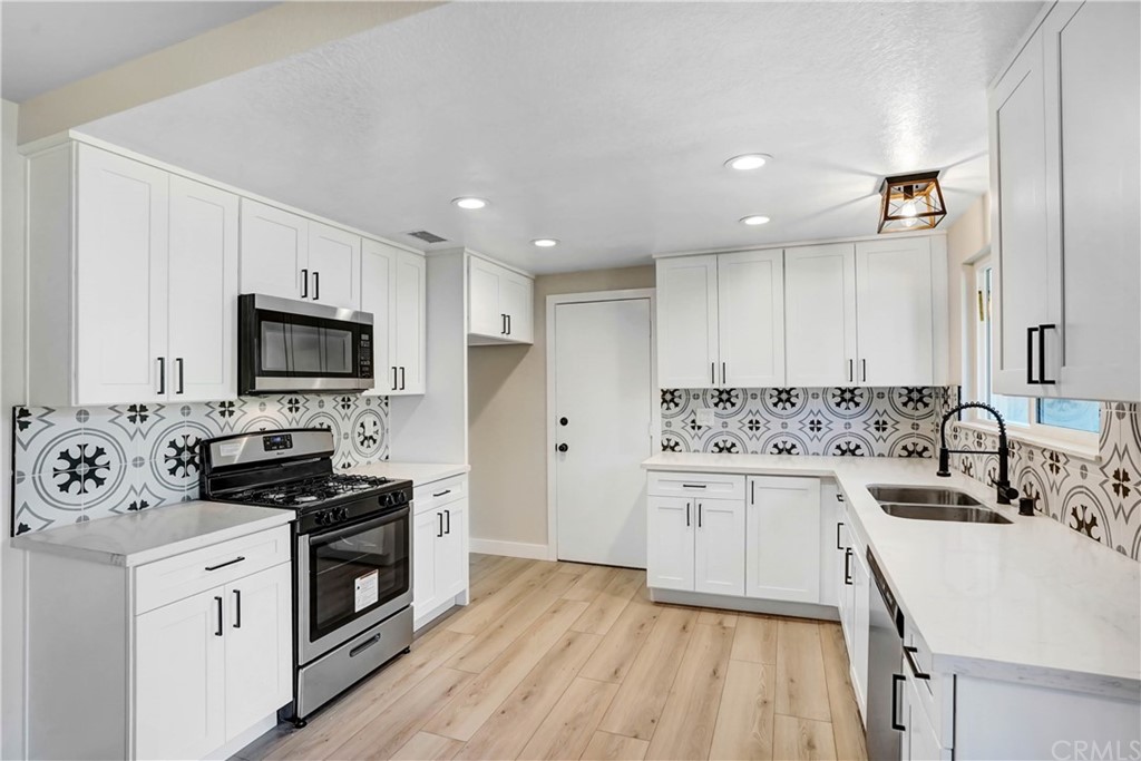 2868 Date Street Riverside, CA 92507 - Photo 1 of 1 a kitchen with stainless steel appliances a stove a sink and a refrigerator