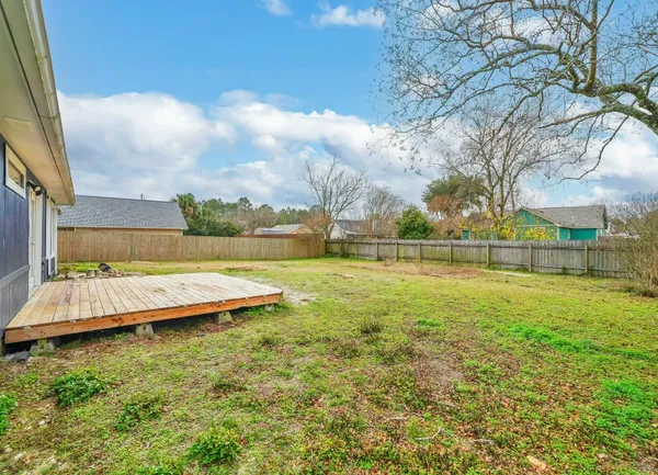 a view of yard with swimming pool and green space