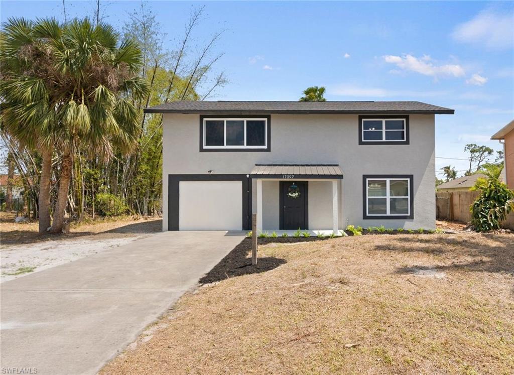 17397 Lee Road Fort Myers, FL 33967 - Photo 1 of 22 a front view of a house with a yard and garage