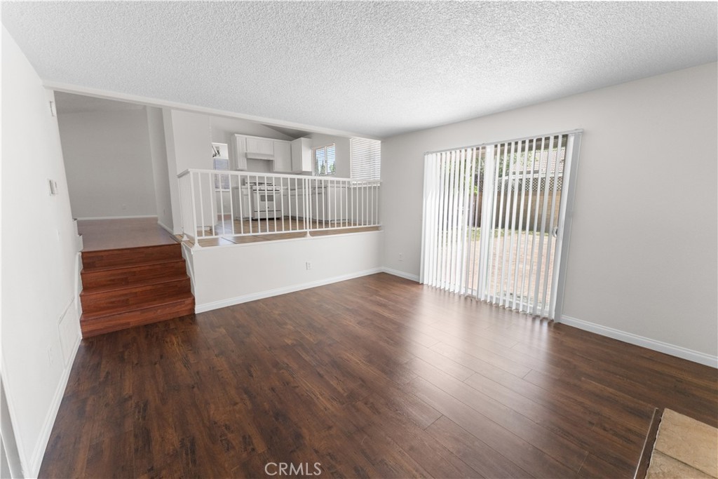 1232 Kings Road Palmdale, CA 93551 - Photo 14 of 32 wooden floor in an empty room with a window