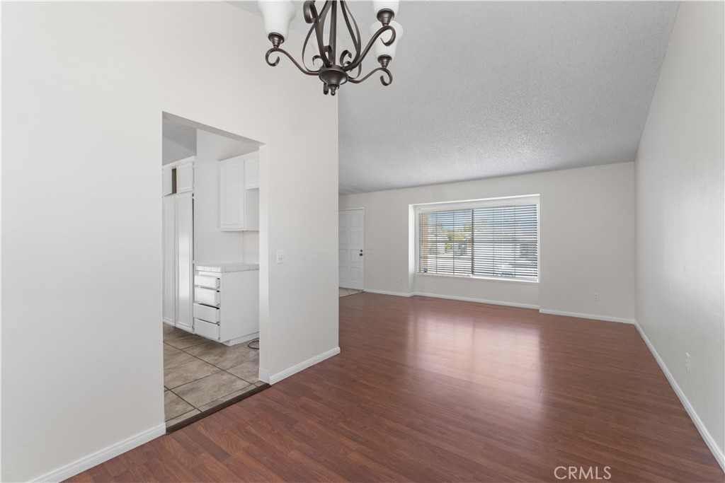1232 Kings Road Palmdale, CA 93551 - Photo 21 of 32 wooden floor in an empty room with a window
