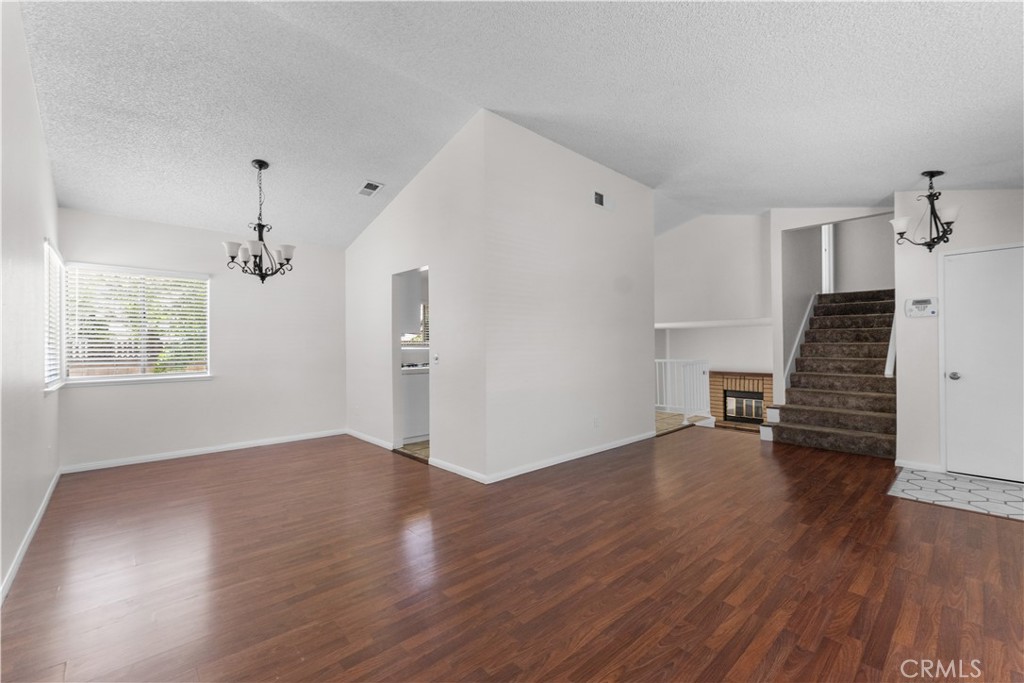 1232 Kings Road Palmdale, CA 93551 - Photo 22 of 32 an empty room with wooden floor and windows