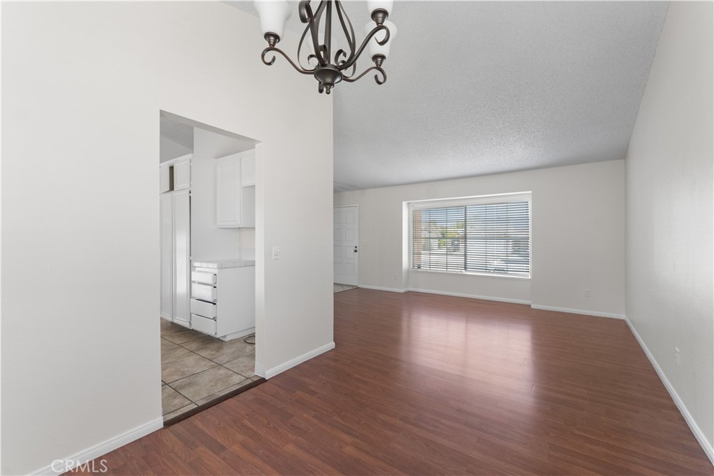 1232 Kings Road Palmdale, CA 93551 - Photo 26 of 32 wooden floor in an empty room with a window