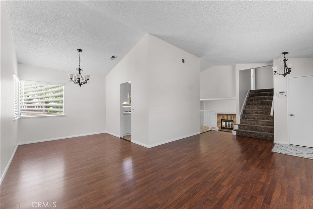 1232 Kings Road Palmdale, CA 93551 - Photo 27 of 32 an empty room with wooden floor and windows