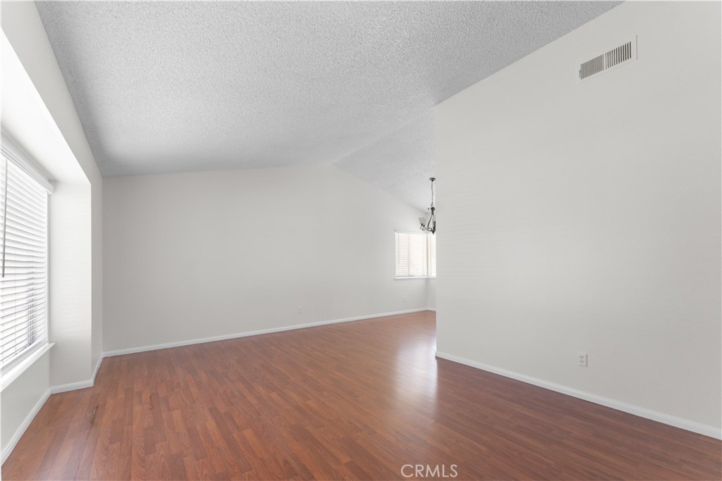 1232 Kings Road Palmdale, CA 93551 - Photo 28 of 32 an empty room with wooden floor and windows