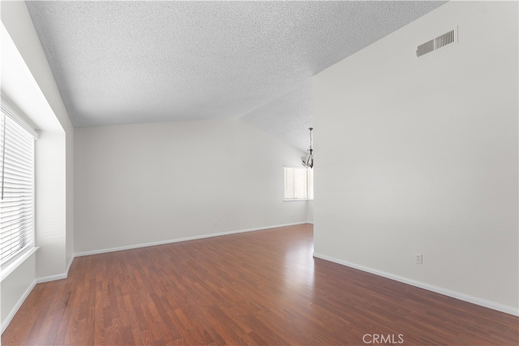1232 Kings Road Palmdale, CA 93551 - Photo 29 of 32 an empty room with wooden floor and windows