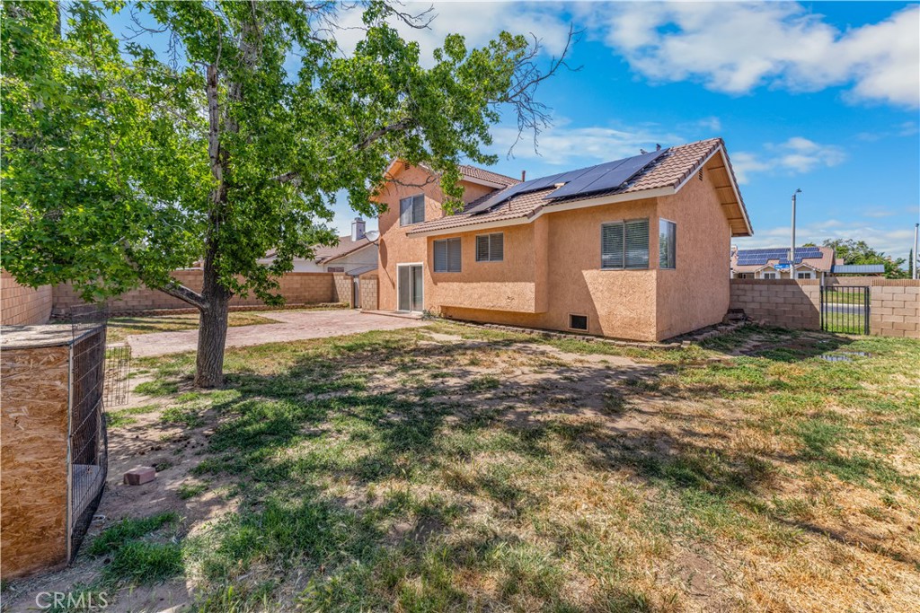 1232 Kings Road Palmdale, CA 93551 - Photo 31 of 32 a view of a house with a yard