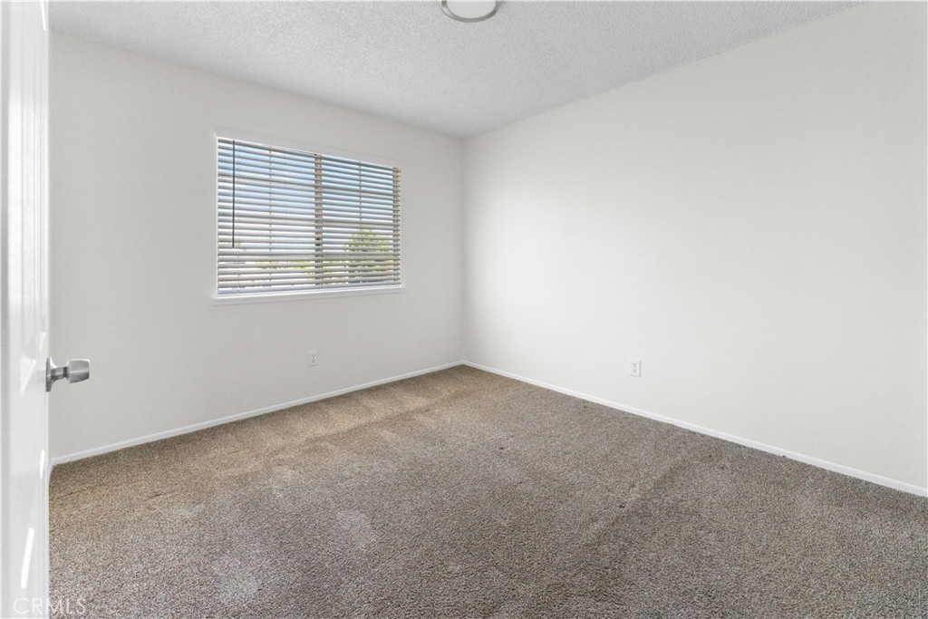 1232 Kings Road Palmdale, CA 93551 - Photo 7 of 32 an empty room with a window