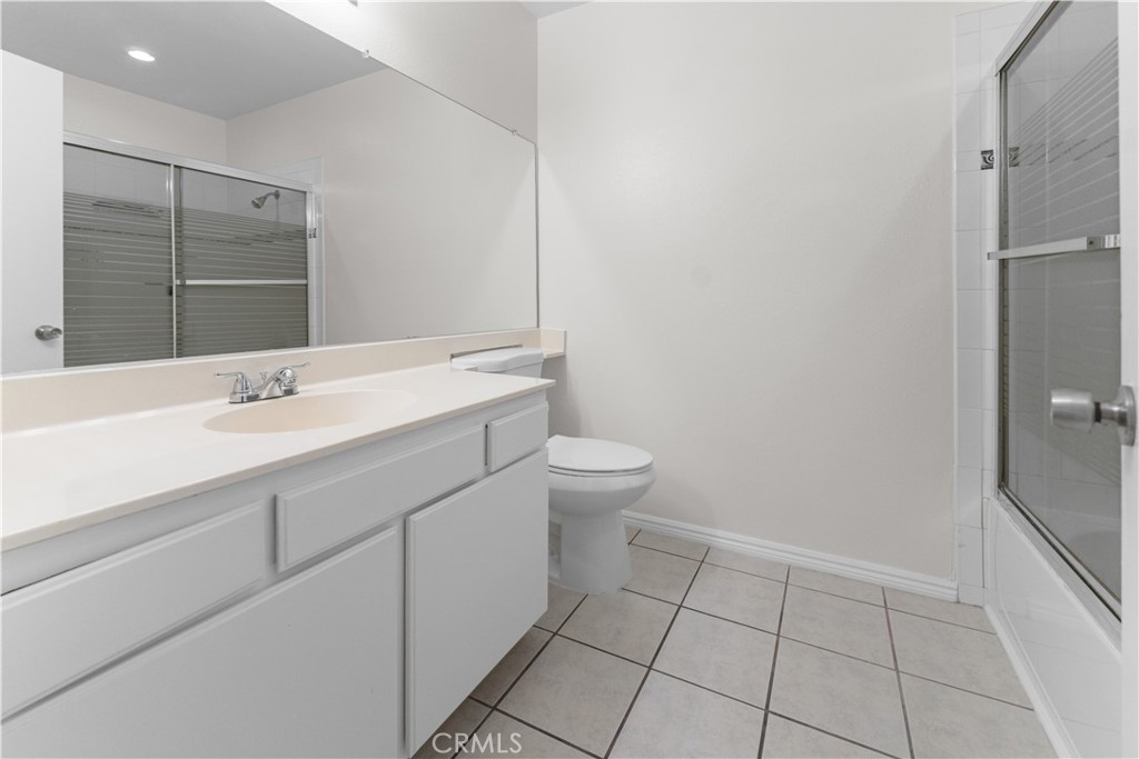 1232 Kings Road Palmdale, CA 93551 - Photo 8 of 32 a bathroom with a sink toilet and vanity
