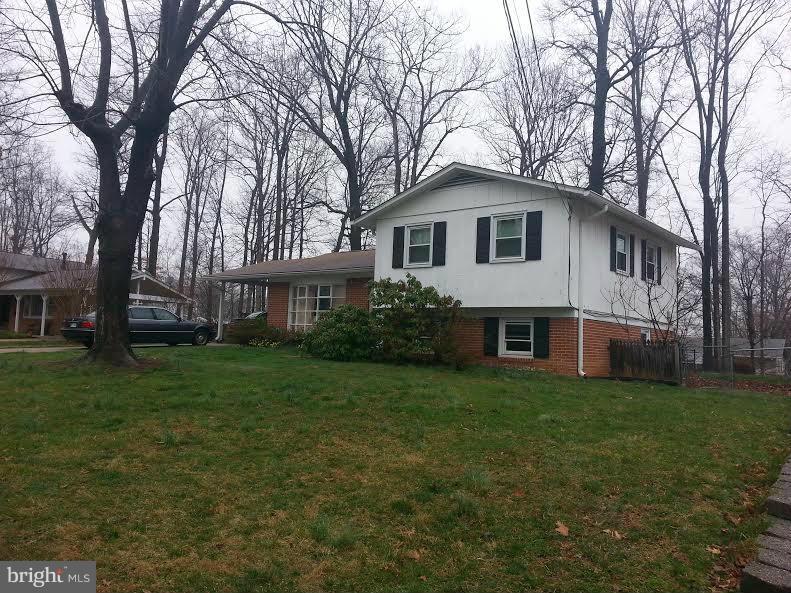 6309 Charnwood Street Springfield, VA 22152 - Photo 2 of 4 a front view of a house with a garden