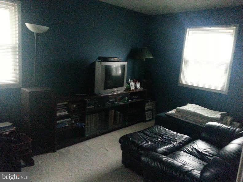 6309 Charnwood Street Springfield, VA 22152 - Photo 3 of 4 a living room with furniture and a flat screen tv