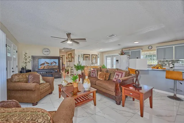 a living room with furniture and kitchen view