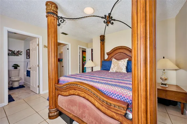 a bedroom with a bed and a mirror