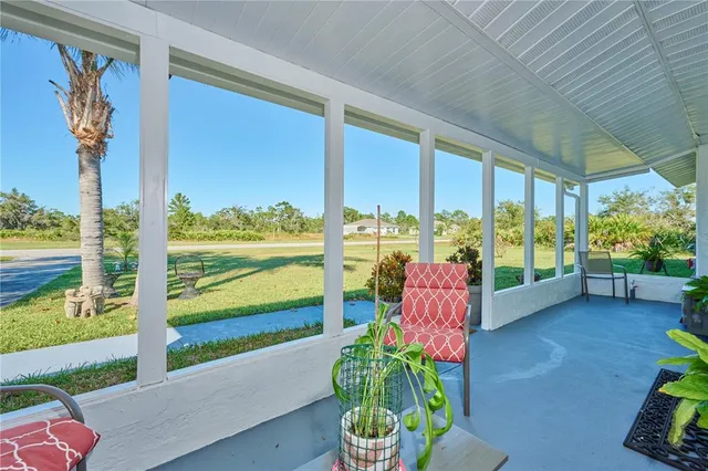 a living room filled with furniture and a floor to ceiling window