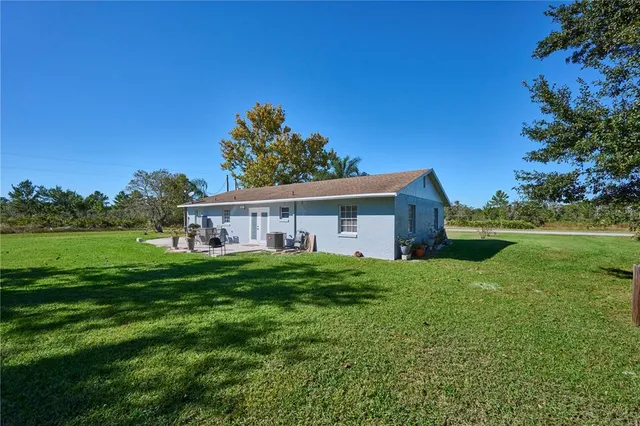 a view of a house with yard and a garden