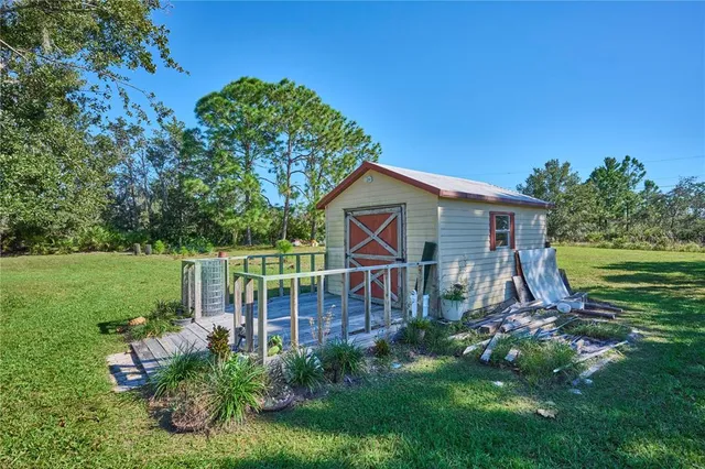 a view of a house with backyard and sitting area