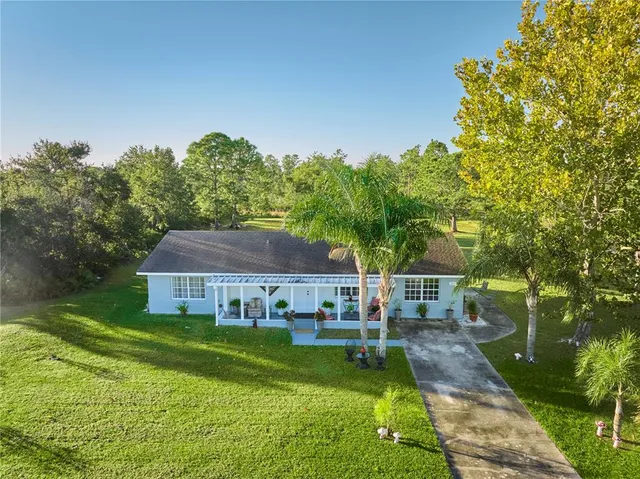 a aerial view of a house with swimming pool garden and patio