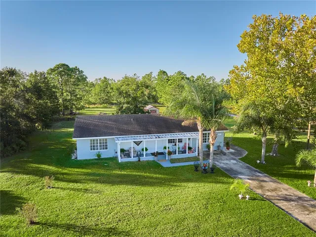 a aerial view of a house with a big yard