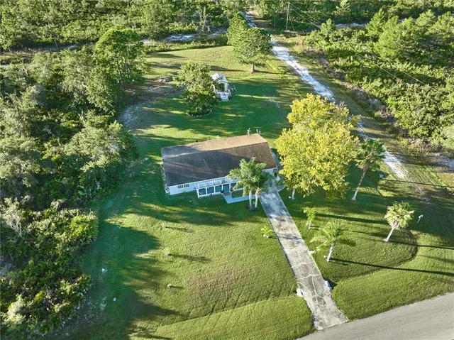 a swimming pool with wooden fence and trees
