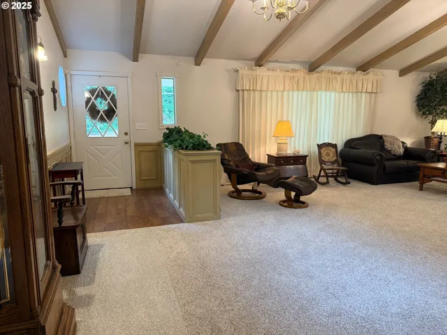 a living room with furniture window and a flat screen tv