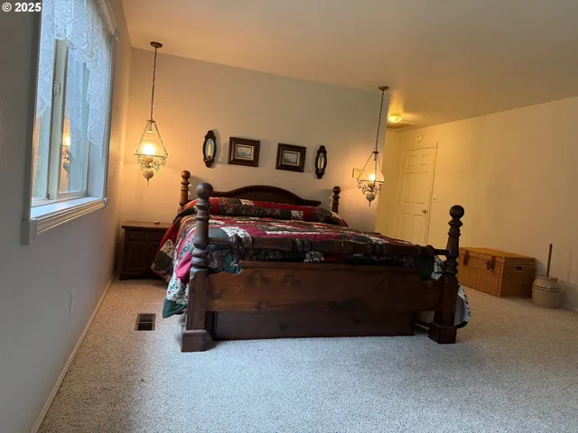a bedroom with a bed and window