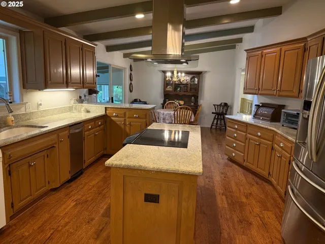 a kitchen with stainless steel appliances granite countertop wooden cabinets a sink and dishwasher