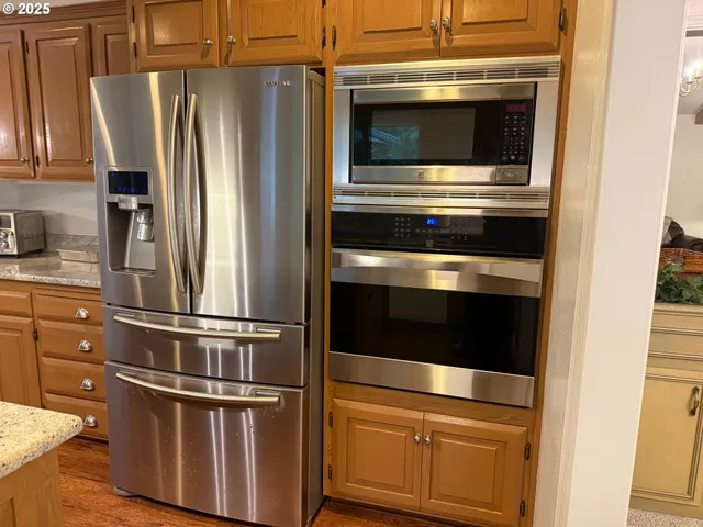 a kitchen with appliances and a refrigerator