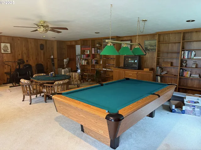 a room with pool table table and chairs