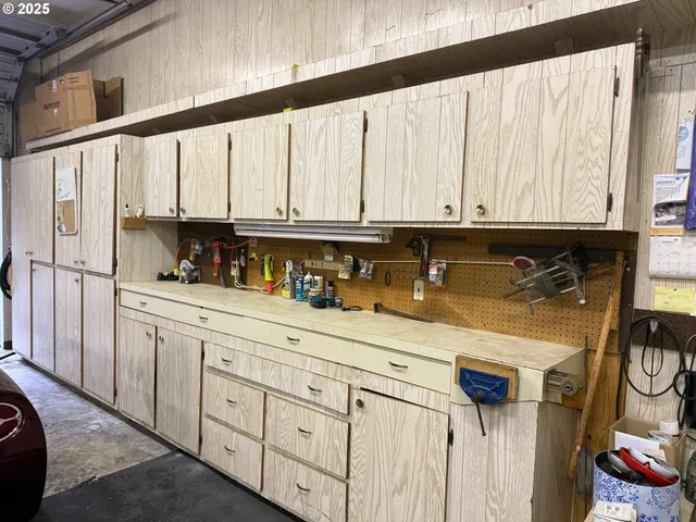 a kitchen with stainless steel appliances granite countertop a sink window and cabinets