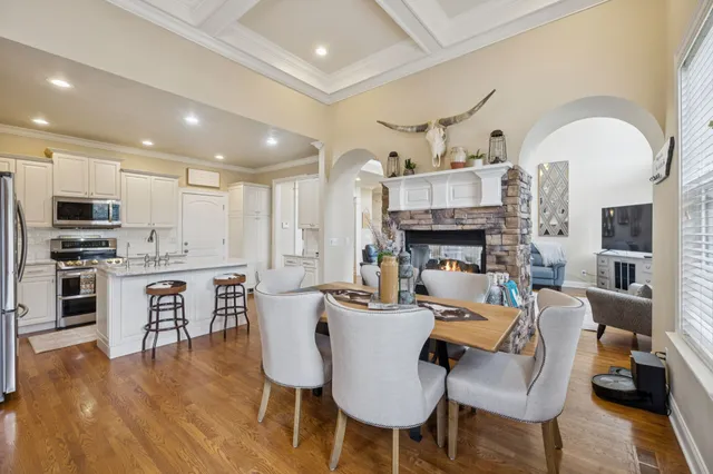 a living room with fireplace furniture and a wooden floor
