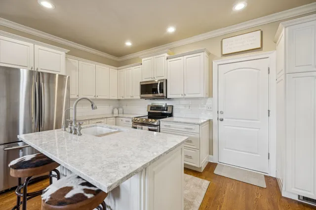 a kitchen with a sink cabinets and wooden floor