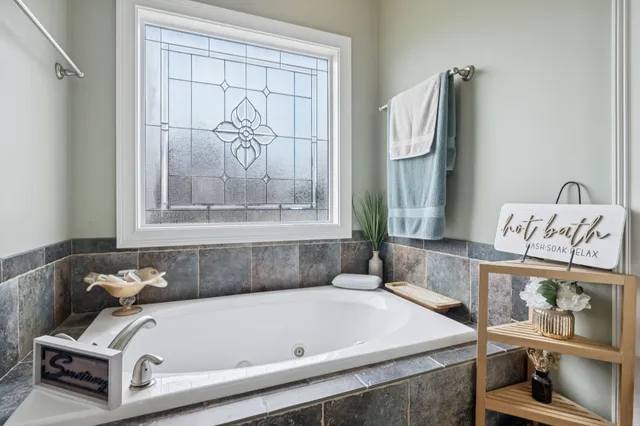 a bathroom with a tub and a window