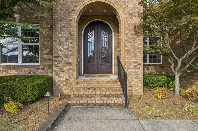 a view of a brick house with large windows