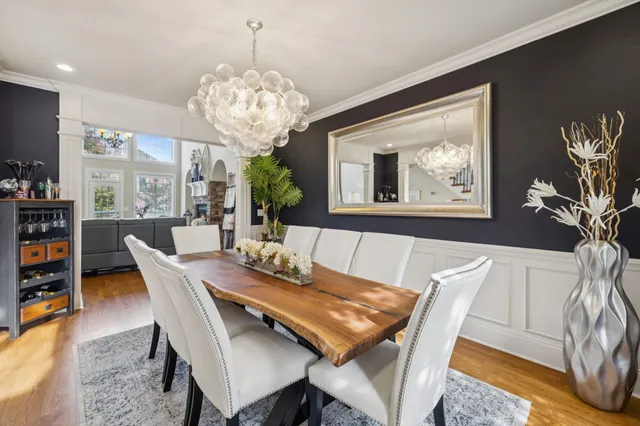 a view of a dining room with furniture and a chandelier