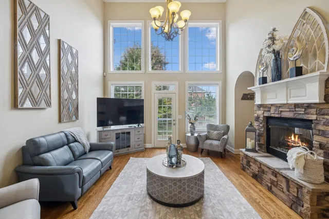 a living room with furniture a flat screen tv and a fireplace