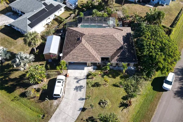an aerial view of a house with a yard and garden