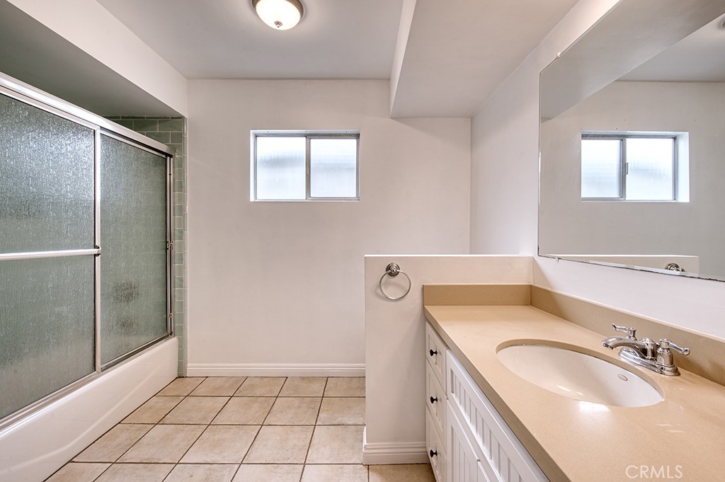 2712 Shell Street Corona del Mar, CA 92625 - Photo 13 of 18 a bathroom with a granite countertop sink a mirror and a shower