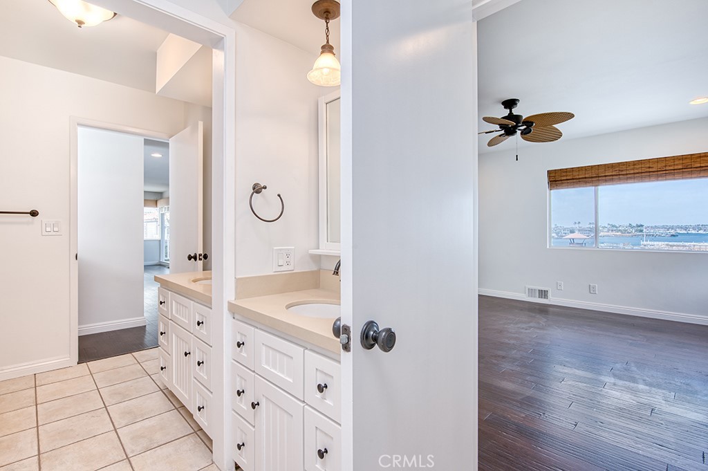 2712 Shell Street Corona del Mar, CA 92625 - Photo 9 of 18 a bathroom with a granite countertop sink a mirror and shower