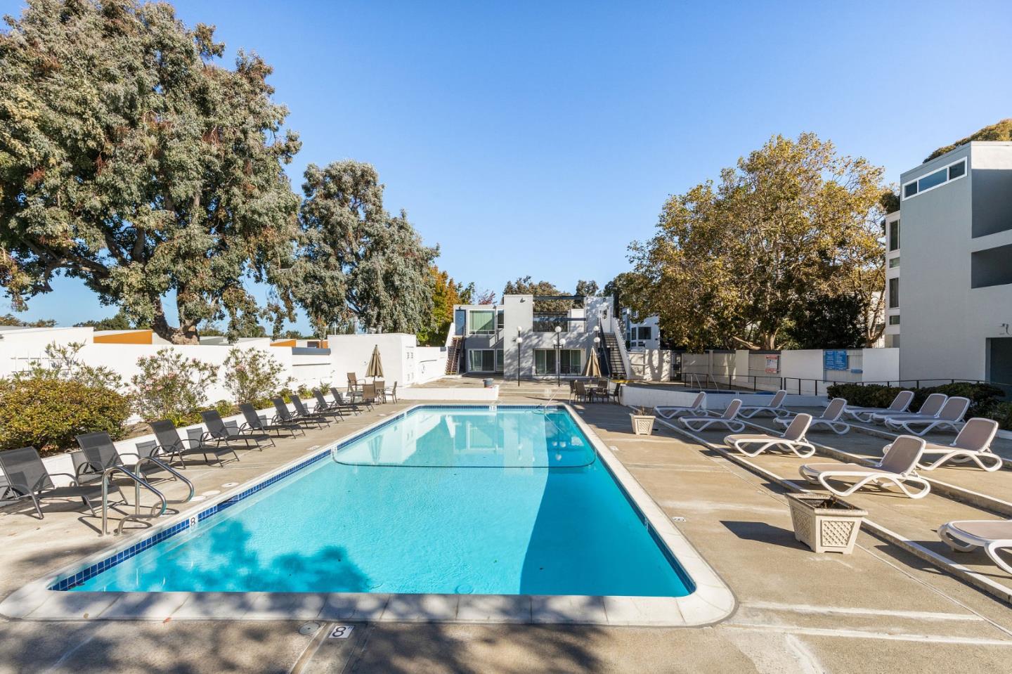 a view of a swimming pool with chairs