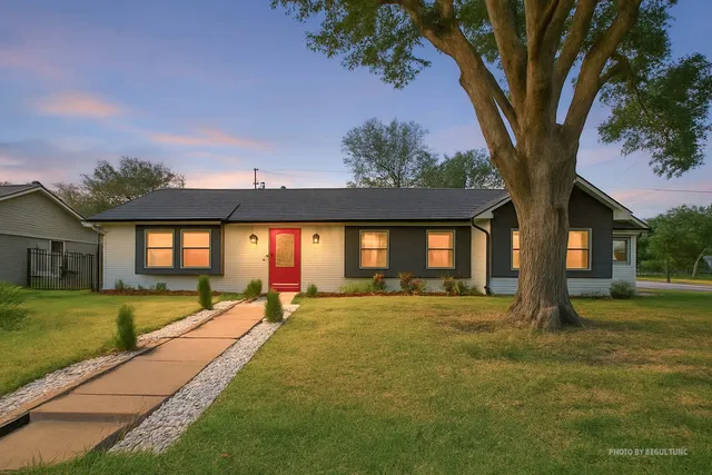 a house with huge green field in front of it