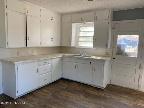 a room with white cabinets and a window