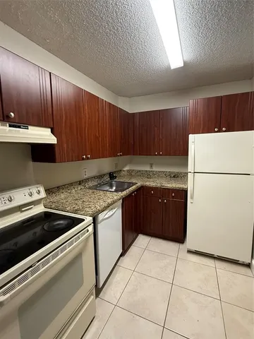 a kitchen with a cabinets and a stove top oven