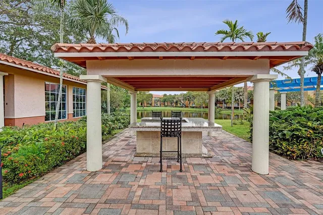 a view of a patio with a table chairs and a backyard