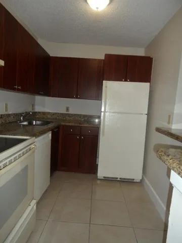 a kitchen with a cabinets and white appliances