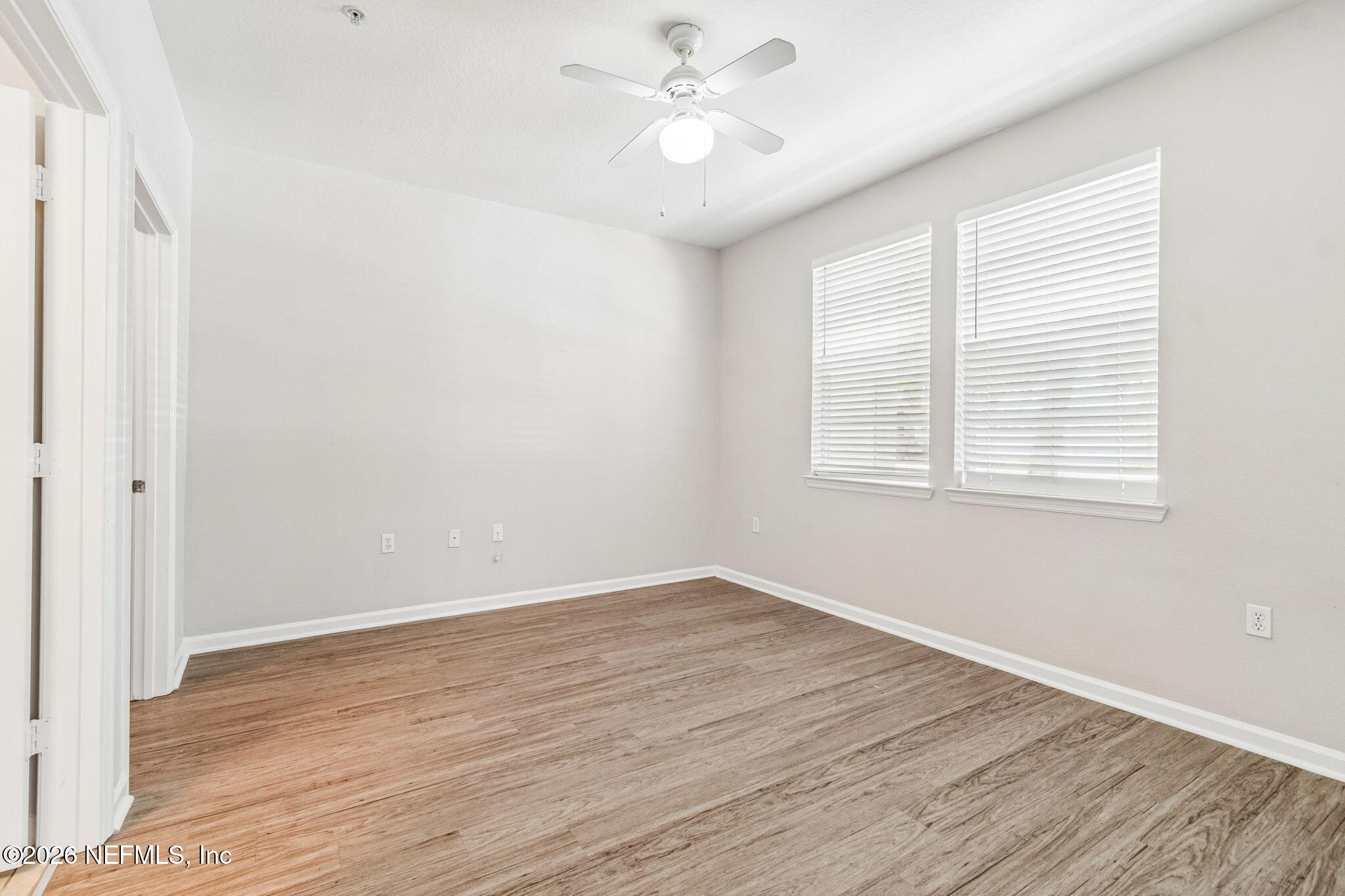 8550 Touchton Road, Unit 511 Jacksonville, FL 32216 - Photo 32 of 63 a view of an empty room with wooden floor and a window